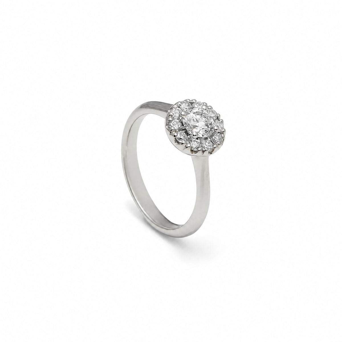 Anillo rosetón de aro liso. El centro incoloro queda rodeado por pequeñas piedras luminosas.