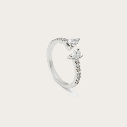 Anillo abierto con motivos de lágrima. Los extremos luminosos se orientan en sentidos opuestos.