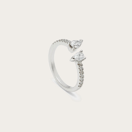 Anillo abierto con motivos de lágrima. Los extremos luminosos se orientan en sentidos opuestos.