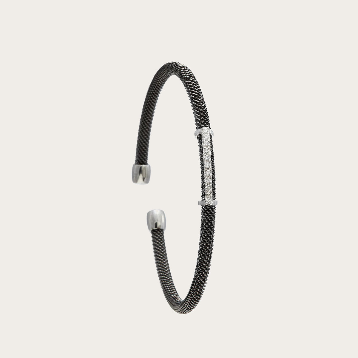 Pulsera de acero, oro y brillantes. El motivo frontal sigue una línea ligeramente curva.