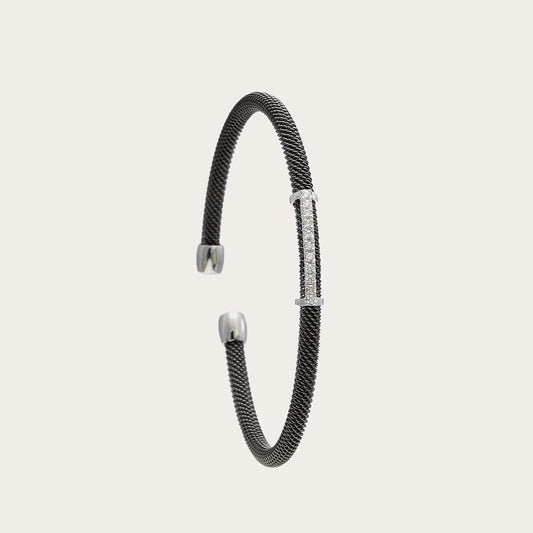Pulsera de acero, oro y brillantes. El motivo frontal sigue una línea ligeramente curva.