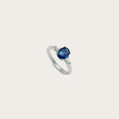 Anillo de centro azul intenso. Las garras visibles recortan el contorno de la piedra frontal.