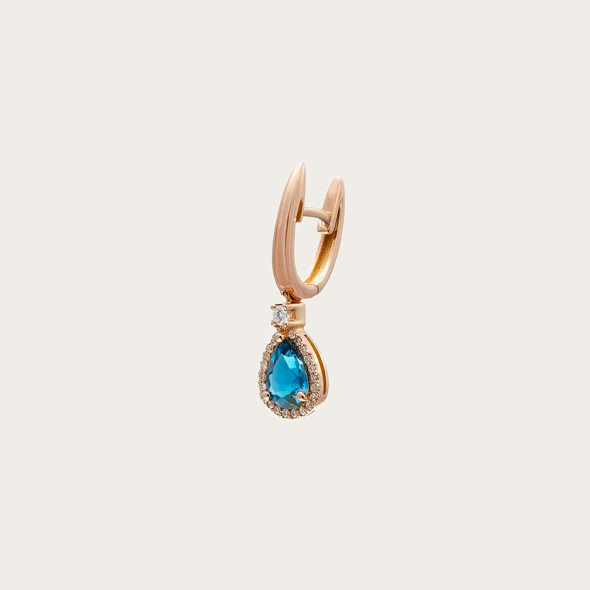 Pendientes de aro dorado y lágrima azul. Un pequeño borde luminoso rodea el centro azul.