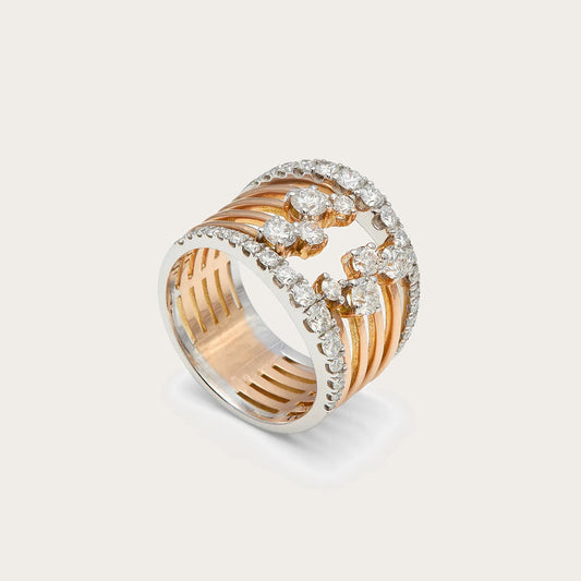 Anillo ancho de bandas y curvas. El frente combina líneas paralelas con un motivo curvo de tono plateado.