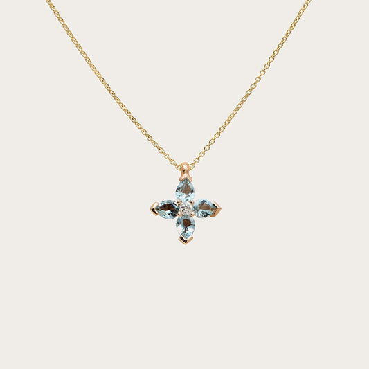 Colgante de cruz con centros de color. Las monturas de tono dorado delimitan los motivos de cada brazo.