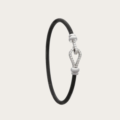 Pulsera de acero y oro de curva luminosa. El motivo alargado conserva un espacio interior abierto.