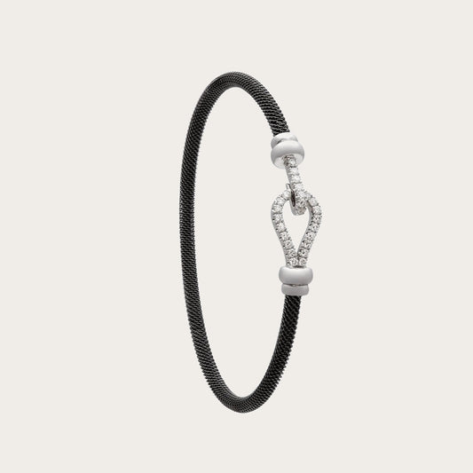 Pulsera de acero y oro de curva luminosa. El motivo alargado conserva un espacio interior abierto.
