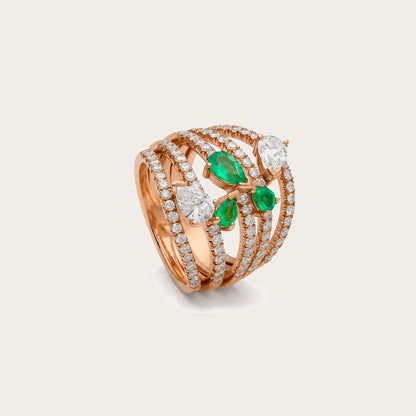 Anillo de esmeraldas y diamantes en lágrima. El frente reúne motivos orientados en diferentes direcciones.