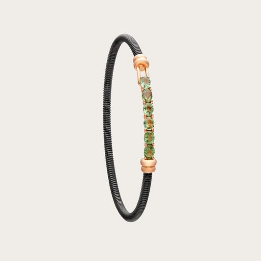 Pulsera de acero y oro con zafiros verdes. Las pequeñas monturas siguen una línea alargada.