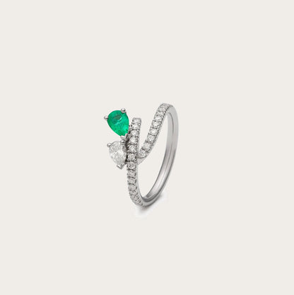 Anillo abierto de esmeralda en lágrima. Las bandas se separan en el frente y sitúan los centros a distinta altura.