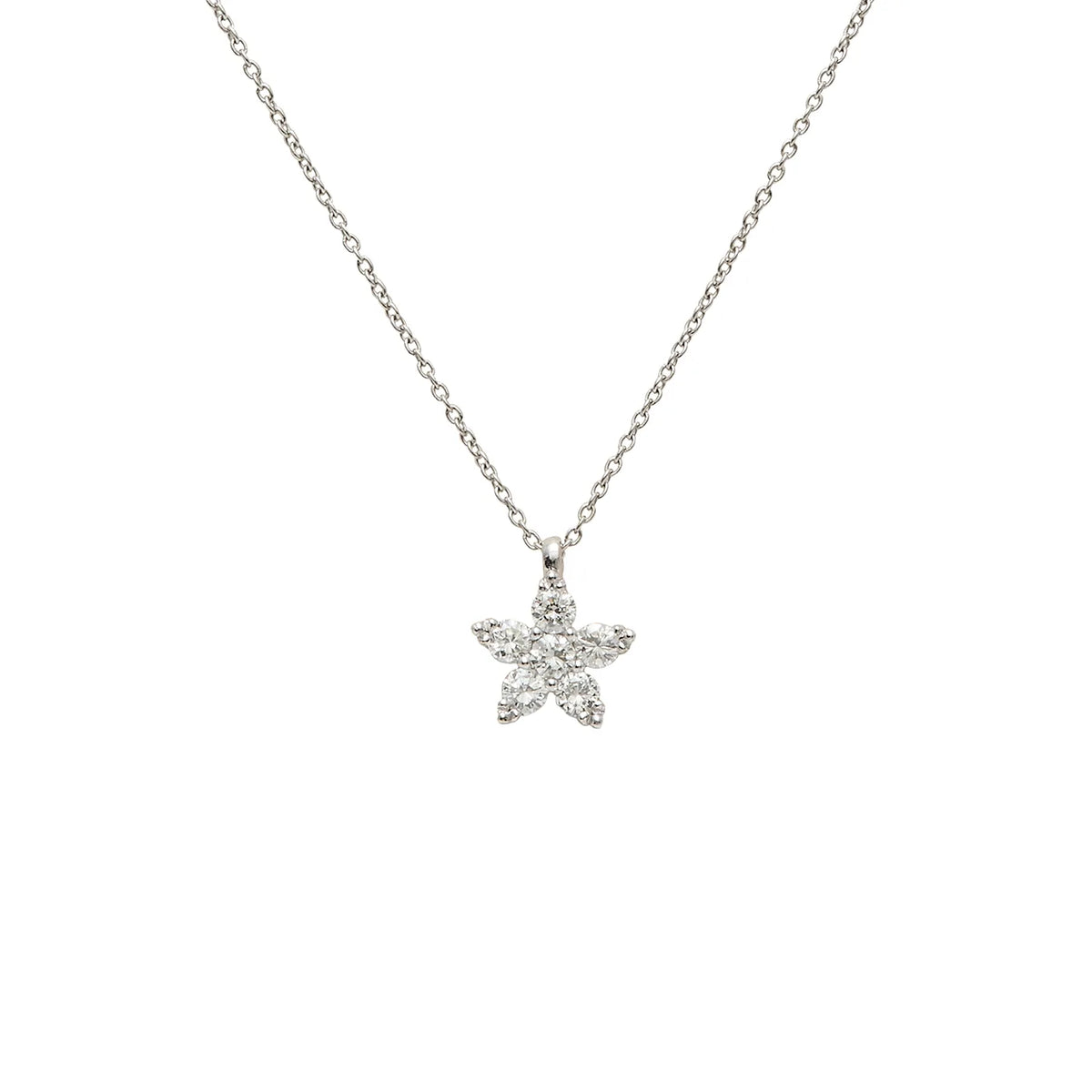 Colgante de estrella luminosa. Las piedras incoloras recorren las puntas del motivo.